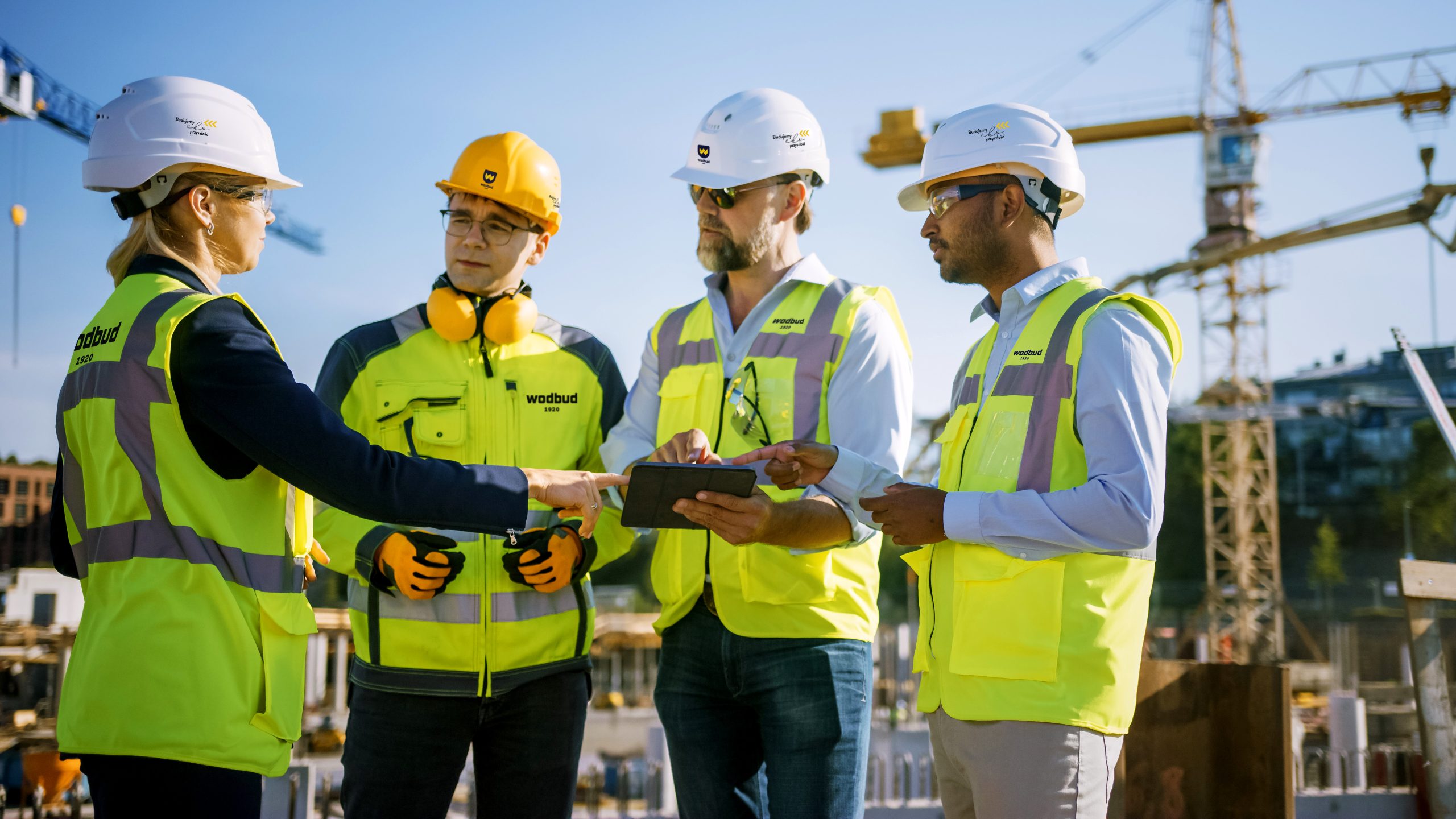Diverse,Team,Of,Specialists,Use,Tablet,Computer,On,Construction,Site.